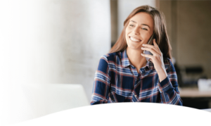 young woman talking on phone while smiling