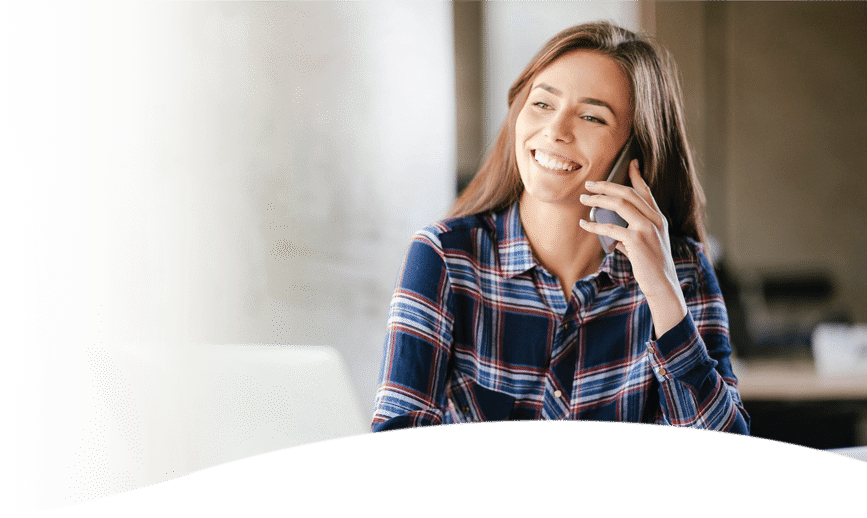 young woman talking on phone while smiling