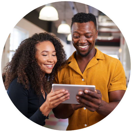 couple sharing a tablet and looking at information while smiling