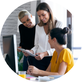 professional woman looking at tablet explaining information to two other women