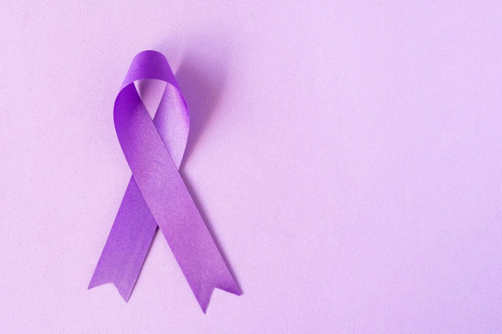 close up of a purple ribbon on a lighter purple background commemorating overdose awareness