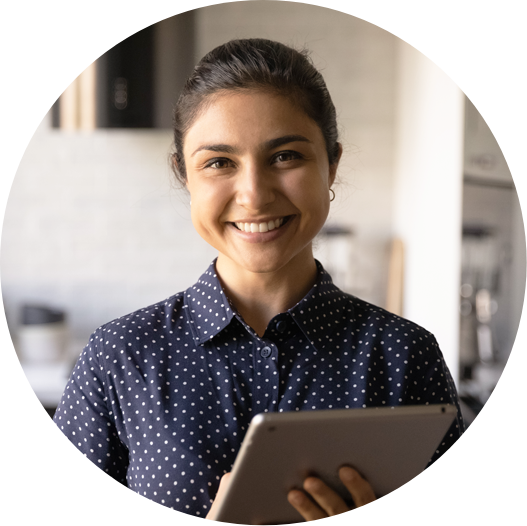 woman staring directly into camera and smiling while holding a table