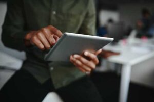close up of man using a tablet to access data
