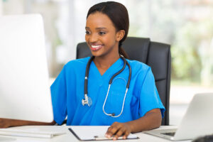 a doctor smiles at a computer as they recognize how lab integration improves patient outcomes