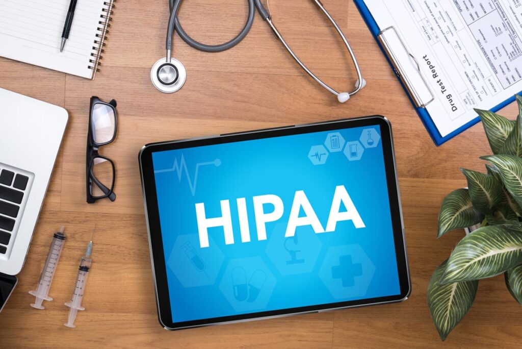 a tablet displays "hipaa" and mental health records are nearby