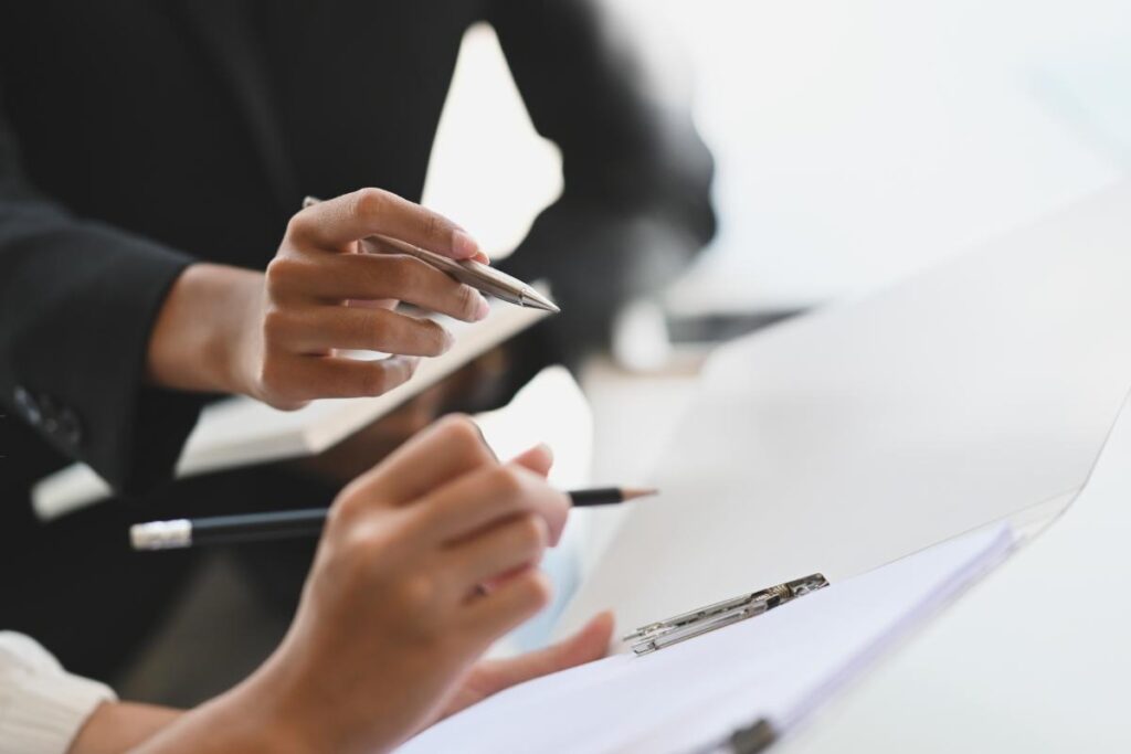 two people look over notes about revenue cycle management