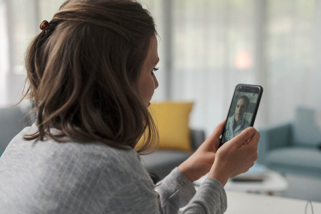 a person talks to a provider on a phone about how telehealth works