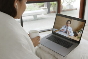 a patient engages with a doctor on a laptop, one of the benefits of telehealth