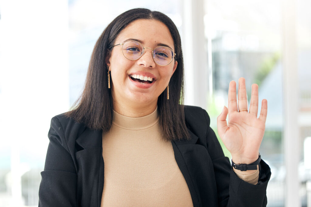 a provider smiles and waves after learning how behavioral health alumni management can help