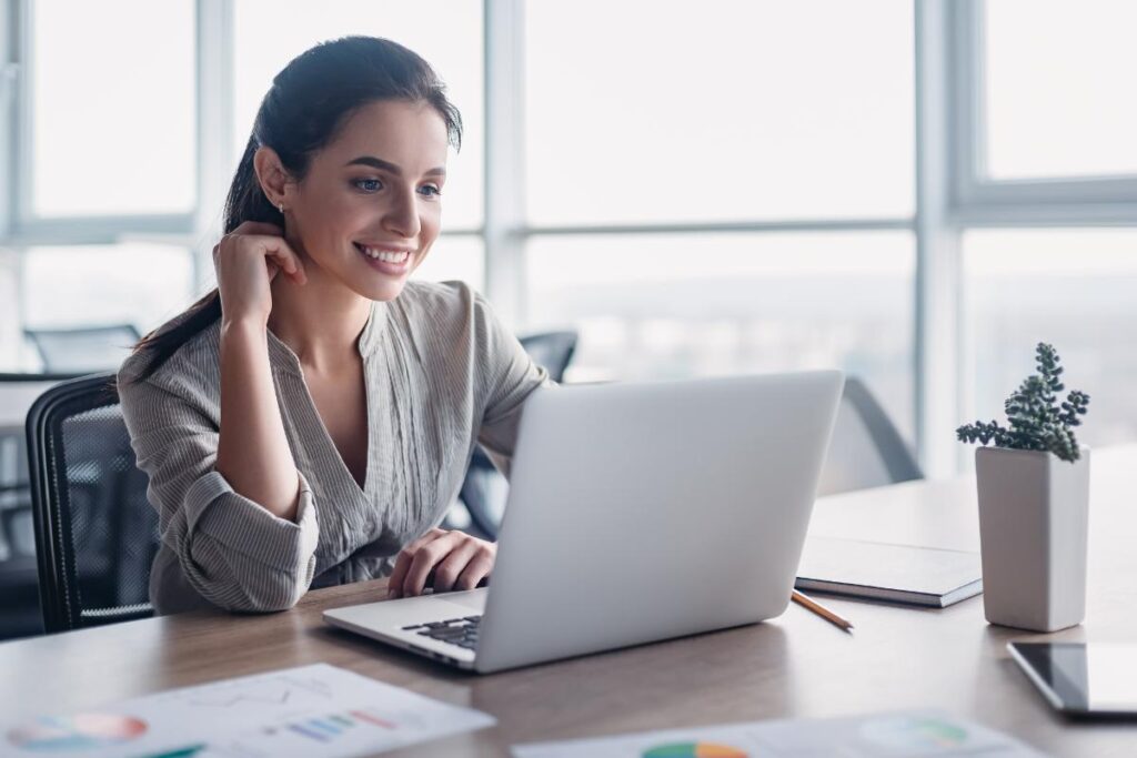 a person uses a computer to research the advantages of customer relationship management