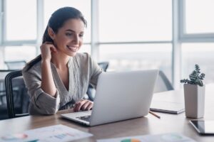 a person uses a computer to research the advantages of customer relationship management