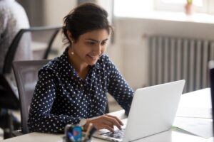 a person uses a computer to research the benefits of financial management for mat clinics