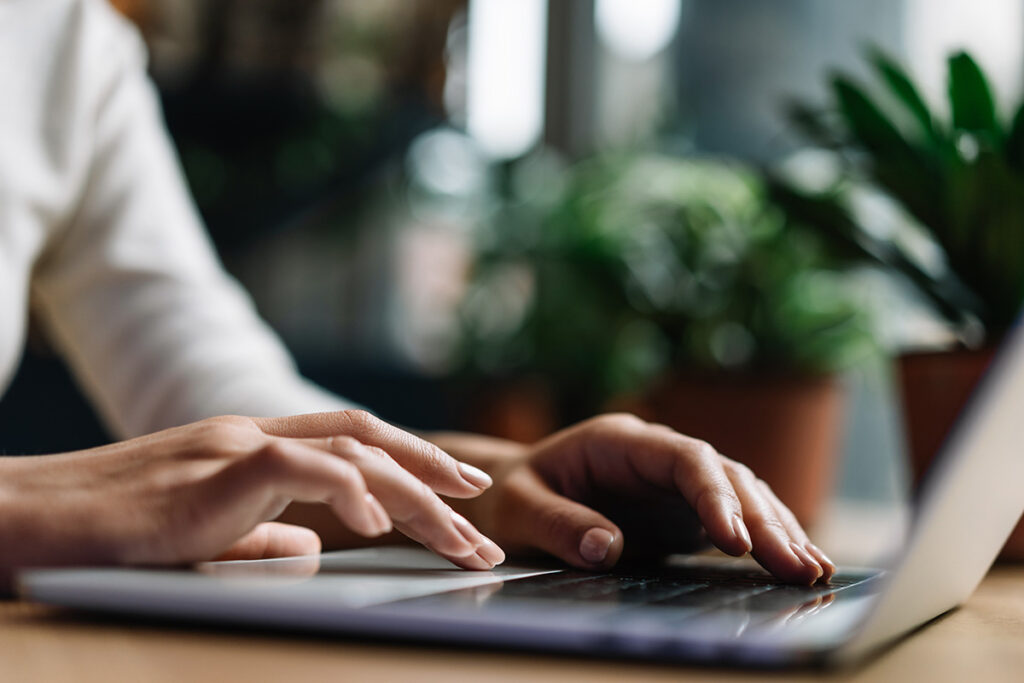 a person uses a laptop to research what ai can do in healthcare
