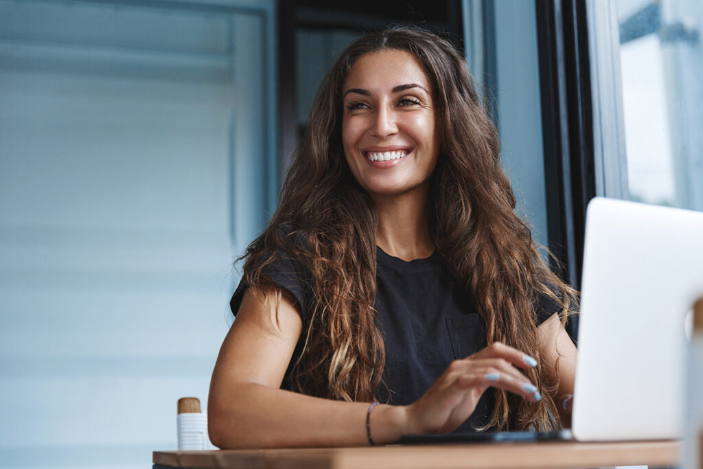 a woman smiles after learning how to increase patient retention after rehab