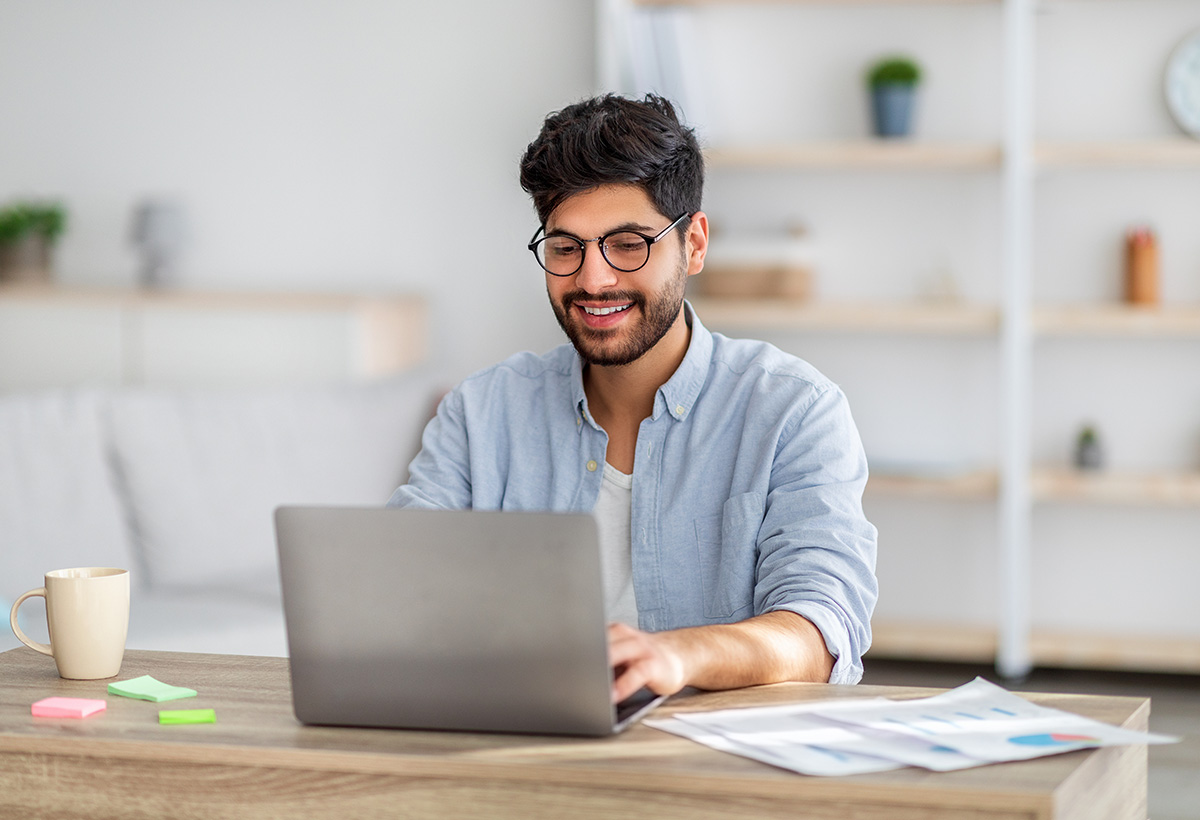 a man uses a computer to research how to streamline admissions process in rehab centers
