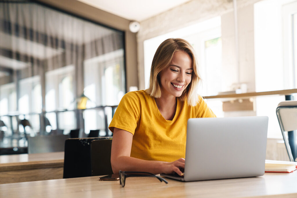 a woman uses a computer to research how to streamline behavioral health workflows