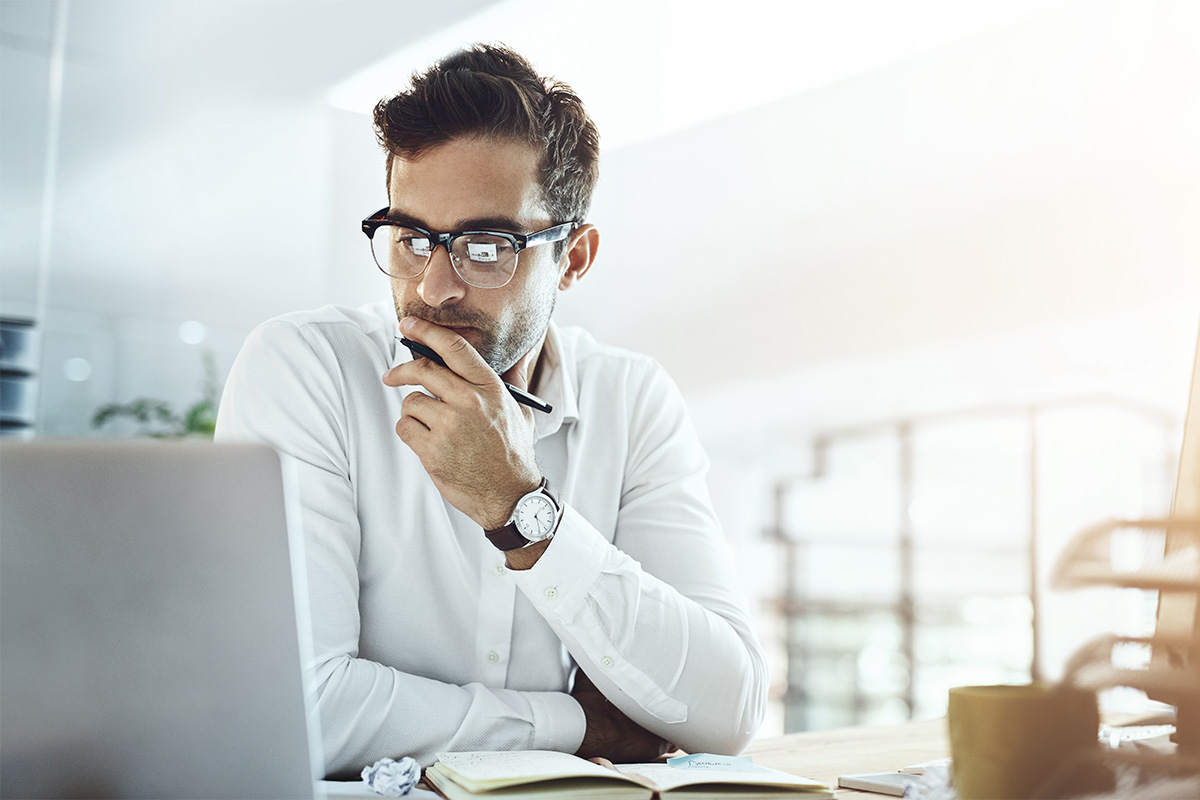 a person uses a computer to research common billing mistakes in behavioral health