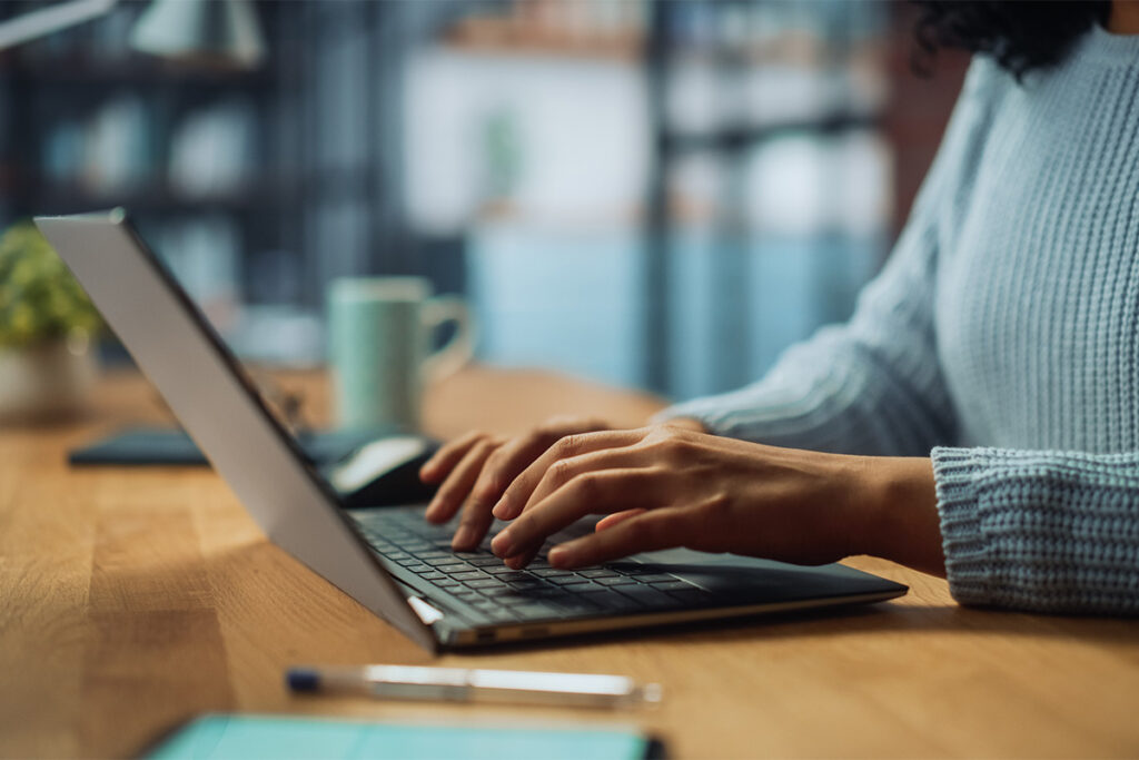 a person uses a computer to research how to reduce no-shows in therapy