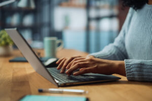 a person uses a computer to research how to reduce no-shows in therapy
